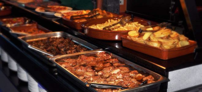 Bandejas de carne guisada, patatas y platos españoles
